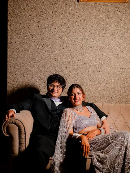 A relaxed and happy portrait of the couple on the couch during their Sangeet. A moment of calm amidst the party.