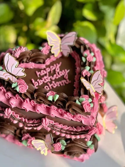Another angle of the butterfly heart cake, capturing the sunlight and showing off the intricate details from a different perspective.