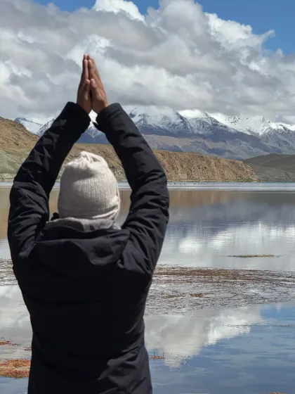 Arms raised in surrender and gratitude towards the sacred waters and mountains. In such moments, the self dissolves into the vastness of the landscape.