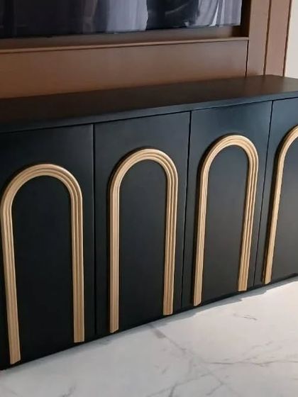 A closer look at the black and gold TV unit, highlighting the clean finish and the elegant arched accents. This piece is a perfect example of our commitment to creating furniture with unique design details.