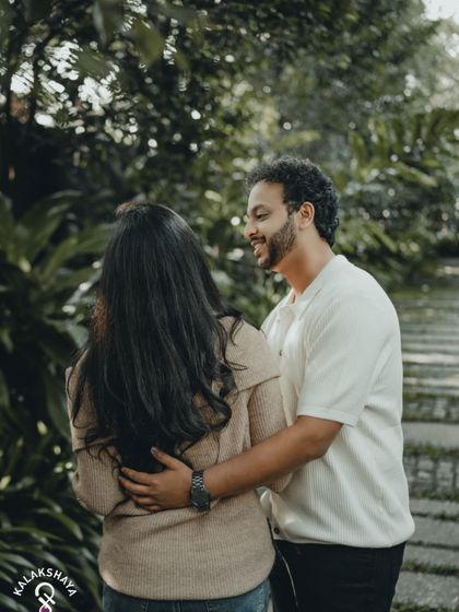 Capturing the look of love. This over-the-shoulder shot creates a personal and intimate perspective during a pre-wedding photoshoot.