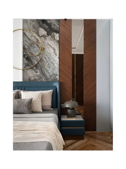 The master bedroom showcases sophistication with a mix of luxurious materials. A dramatic marble panel is flanked by diagonal wood paneling, with brass art and a leather-upholstered bed creating a rich, layered look.
