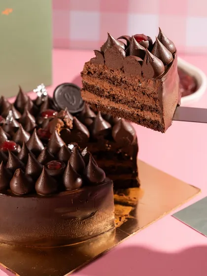 The perfect slice pull from a decadent chocolate cherry cake. Capturing the texture and layers is key to making desserts look as delicious as they taste.