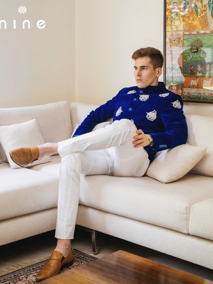 Our royal blue elephant bandhgala, styled for a relaxed yet sophisticated look. It pairs beautifully with simple white trousers, letting the jacket be the star of the show.
