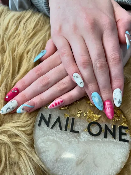 Another angle of the fun, multi-colored manicure with stars and rhinestones. This look is perfect for anyone who loves to experiment with their nail art.
