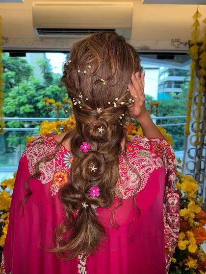 A close-up of the whimsical Mehendi braid, showing the beautiful details of the star accessories and flowers.