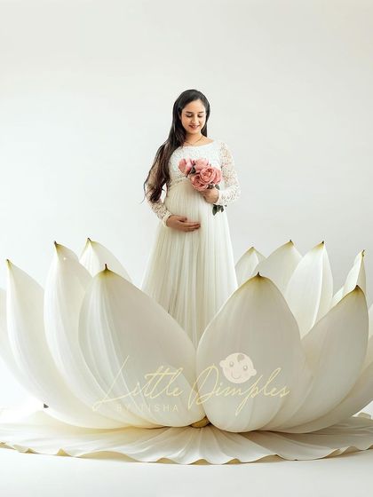 A moment of pure serenity. I love using props like this giant lotus flower to create a unique and artistic setting for your maternity portraits.