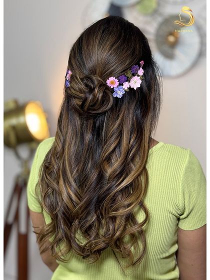 A new trend for the upcoming bridal season: a soft half-updo adorned with real pressed flowers.