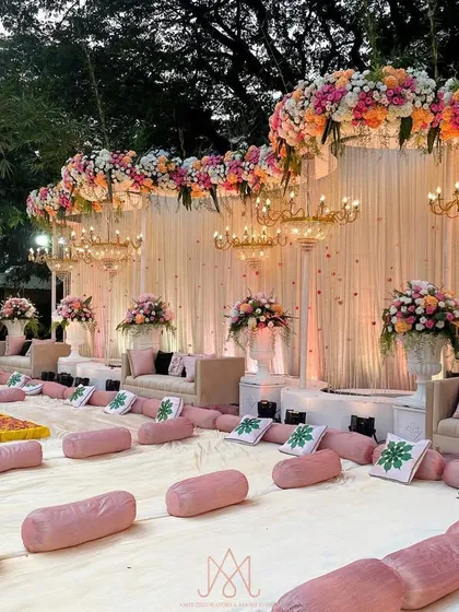 I designed a mix of seating for this event, including traditional floor seating with plush pink bolsters and elegant sofas, all facing the beautifully decorated stage.