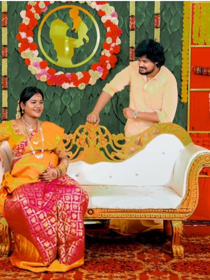 Posed portraits are an important part of any event. Here, the couple poses on an ornate chaise lounge, creating a regal and memorable photograph from their baby shower celebration.