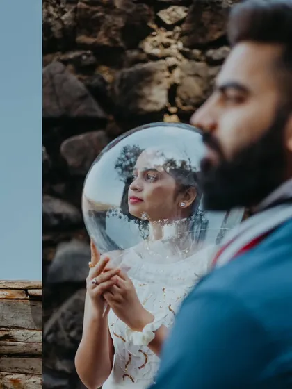 A creative portrait using a spherical prop to frame the bride-to-be's face, adding a unique and futuristic touch to the Alibag shoot.