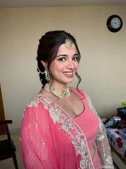 A beautiful portrait showing the complete look. The soft pink tones and natural makeup enhance her youthful glow.