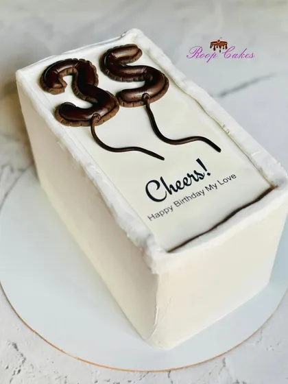 A toast to 35, made sweeter with cake. This minimalist design features edible number balloons for a modern and chic celebration.