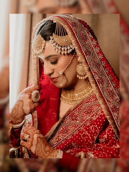 A portrait of a bride in her final moments of preparation. We focus on capturing the elegance and emotion, highlighting the intricate details of the bridal attire, the traditional jewelry, and the quiet anticipation before she walks towards her new beginning.