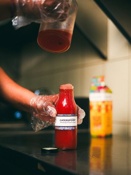 Freshness, bottled. This shot captures the moment we pour our vibrant, healthy juice, a testament to our commitment to fresh, natural ingredients.