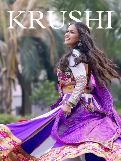 A beautiful action shot from a Navratri-themed pre-wedding event. The bride's makeup is vibrant and long-lasting, perfect for a night of garba and dancing.