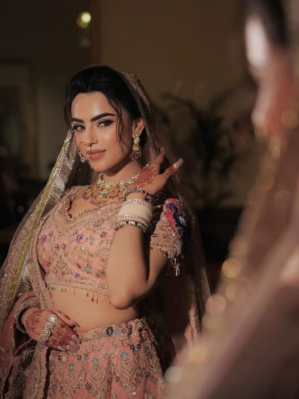 The bride looking at her reflection. This shot captures a moment of quiet confidence, her pastel glam looking absolutely perfect.