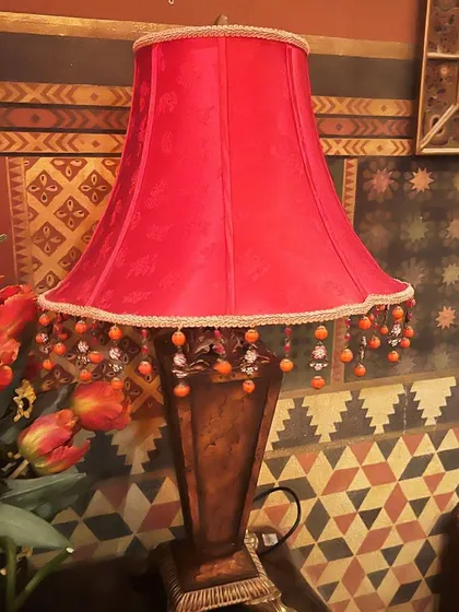 Sourcing unique pieces is a major part of my process. I found this vintage red lamp on a sourcing trip, and it now adds a perfect pop of color to a client's den. A single, well-chosen object can completely elevate the mood of a room.