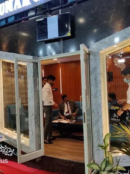 A glimpse into a client consultation taking place within our sample container office. The interior is designed to be a quiet, insulated, and productive environment, even in the middle of a busy exhibition hall.