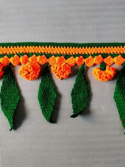 This orange marigold and green leaf toran is perfect for Navratri, Diwali, or any celebration. It brings a festive and traditional feel to your home.