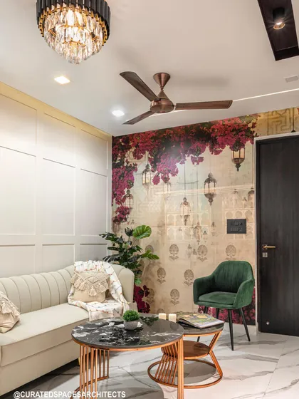 This view shows the interplay of different elements: the classic wall paneling, a bold floral wallpaper, and modern furniture in jewel tones, all coming together in one cohesive design.