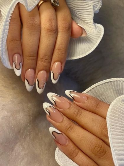 White never goes out of style. We gave the classic French manicure an artistic twist with this abstract black and white design for a look that is modern and chic.