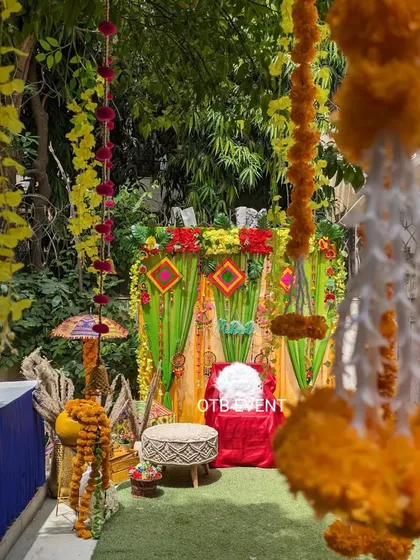 A view through hanging marigold garlands of the colorful Mehendi seating area. I love creating these layered looks that are perfect for photos.