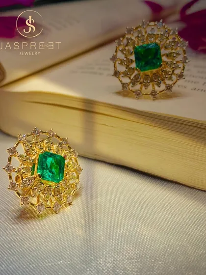 Two of my emerald and diamond cocktail rings, crafted in 22kt gold. The intricate, web-like setting of the diamonds creates a delicate frame for the rich green of the central emeralds.