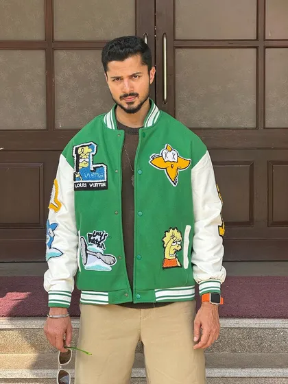 A confident and stylish pose in a modern, trendy jacket.