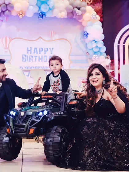 A fun family photo with everyone pointing up, celebrating the birthday boy.