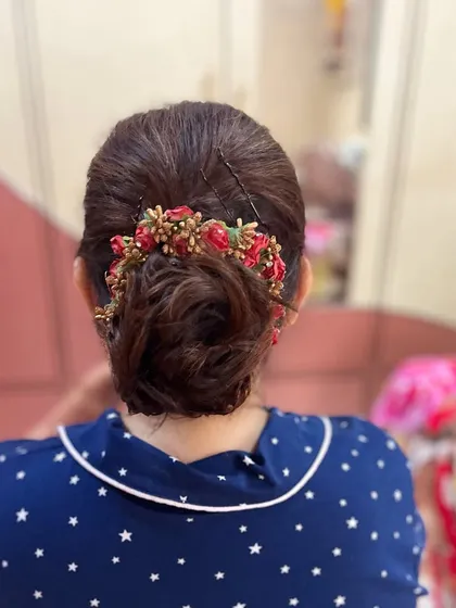 Another angle of the messy bun, showing the texture and detail of the hairstyle.