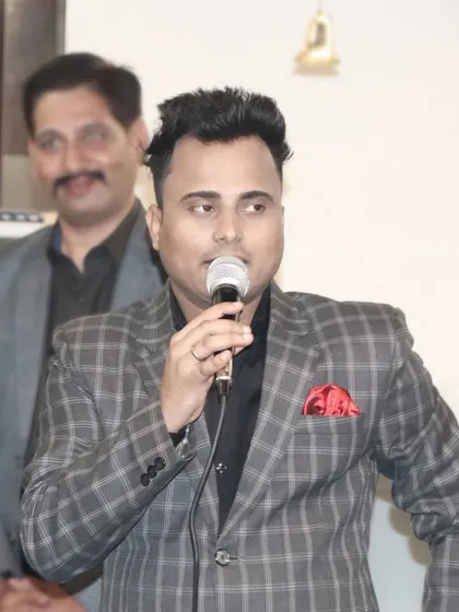 A guest holding a microphone, likely giving a speech or performance. I document all the planned activities and entertainment at your party.
