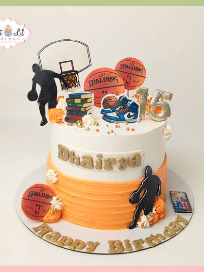 A slam dunk of a cake for a basketball lover's 15th birthday. This two-tiered cake is decorated with basketballs, sneakers, and player silhouettes.