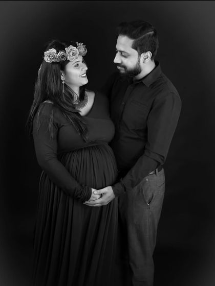 A timeless black and white portrait of a couple. The focus is entirely on their expressions and the gentle way they hold each other.