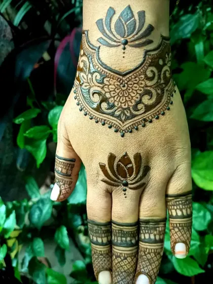 A self-applied lotus design I did on my own hand. It features a bold lotus on the wrist and a smaller one on the finger, connected by delicate patterns.