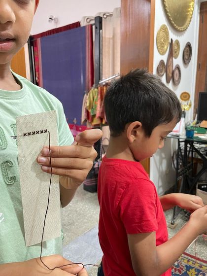 A close-up of my grandson learning his first stitches. It's a simple, powerful way to teach hand skills and patience.