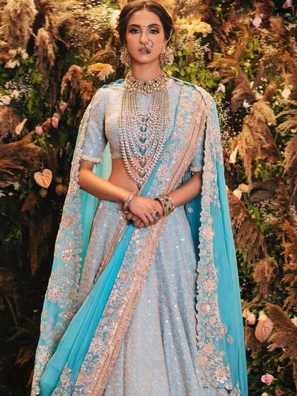 A breathtaking look for the modern bride. The powder blue lehenga is paired with soft, ethereal makeup and statement layered jewellery, creating a look that is both trendy and timeless.