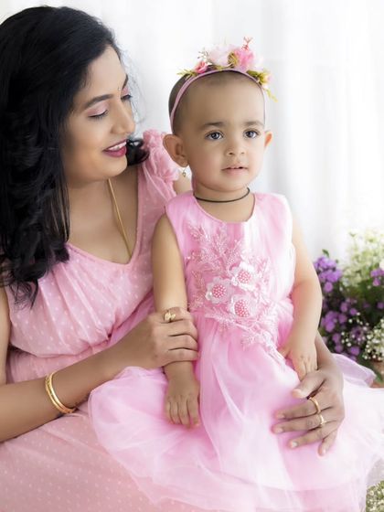 A serene and loving portrait of a mother and her daughter sharing a quiet moment together.