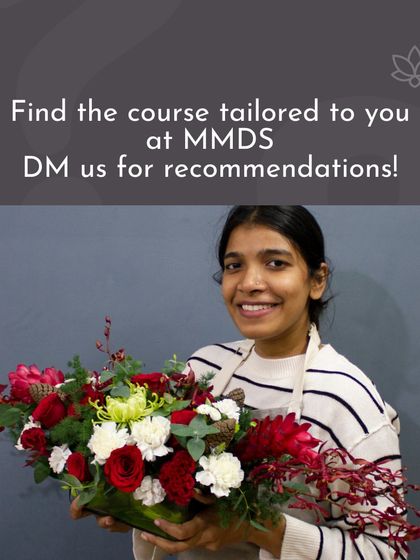 A student proudly holds her finished piece, a vibrant mix of red and white flowers. This is the kind of beautiful, professional-quality work my students learn to create.