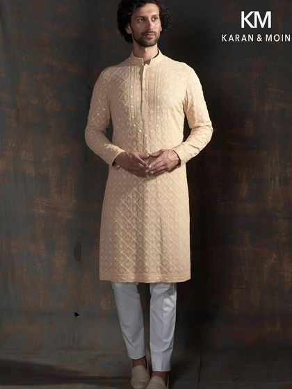 The full silhouette of the ivory shadow kurta. Paired with white trousers and minimalist loafers, it is an ideal look for Rakhi gatherings or other heirloom memories, a couture piece that feels like legacy.