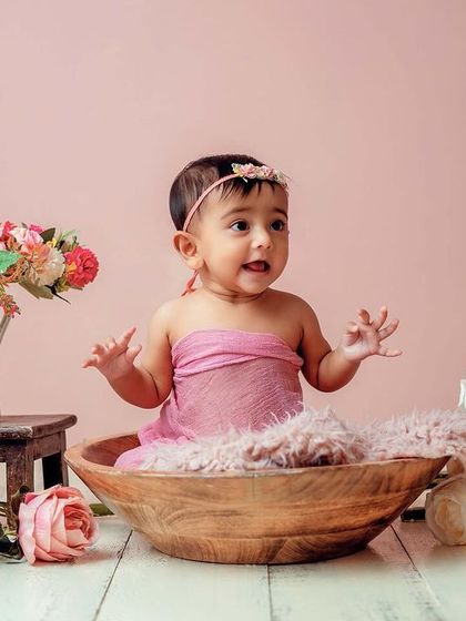 So much excitement. The all-pink floral setup creates a soft and dreamy atmosphere for this beautiful baby girl's milestone session.