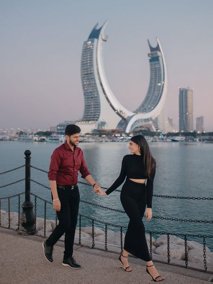 A stylish walk along the waterfront in Qatar, with the iconic Katara Towers in the background. This shot blends modern architecture with the couple's elegant chemistry.