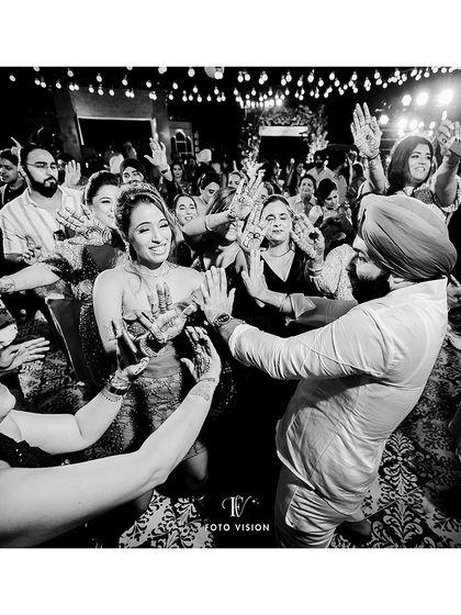 The couple in the center of the dance circle, surrounded by their friends and family. We capture the community and joy of everyone coming together to celebrate.