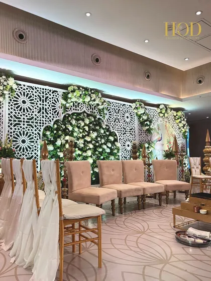 A wider view of the Pichwai-inspired stage, showing the elegant seating arrangement and how the traditional art is integrated with modern decor.
