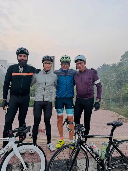 Four friends posing with their bikes after a ride.
