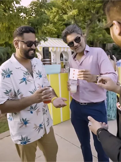 Demonstrating a card trick to a group of influencers at the Tissot event. The sunny, outdoor setting was perfect for some casual, mind-bending magic.