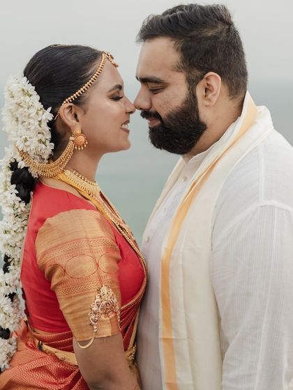 A romantic portrait of the couple by the sea, their traditional Telugu wedding attire looking timeless and elegant.