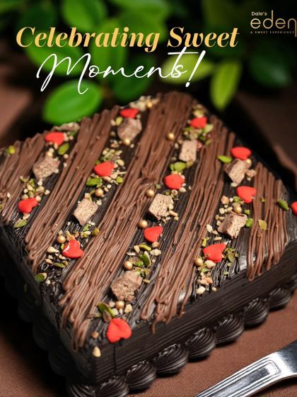 Celebrating sweet moments with this beautifully decorated chocolate cake. The combination of chocolate drizzle, chopped pistachios, and tiny red hearts makes it a feast for the eyes and the palate.