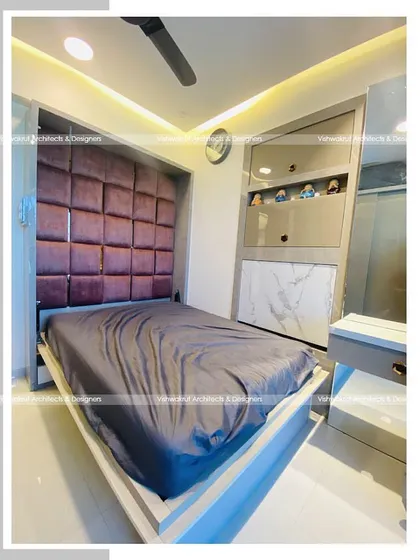 The wall-mounted bed in the 9x9 feet kid's bedroom, shown in its open position. The bed features a comfortable upholstered headboard and provides a full-size sleeping area while being incredibly space-efficient.