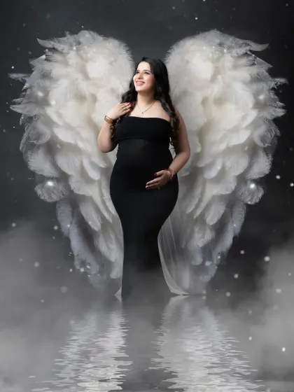 An angel in black. This dramatic portrait contrasts a simple black gown with our beautiful white angel wings, creating a powerful and striking visual.